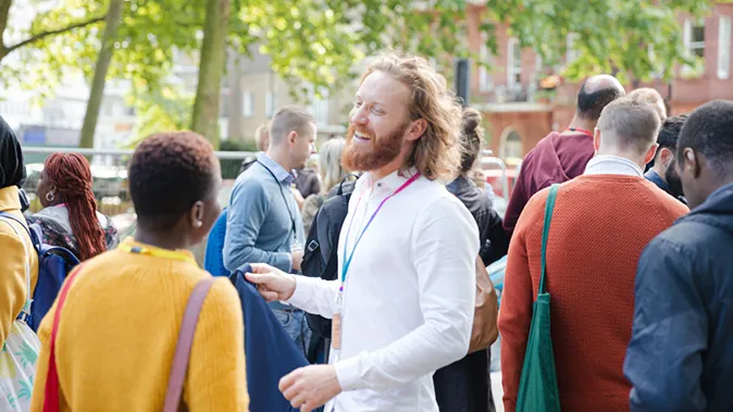 Veranstaltungen Gesundheitsämter Mann eines Organisationsteams spricht mit Frau